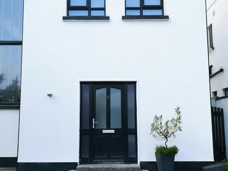 Smooth white silicone render on a modern UK home